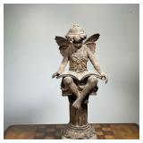 SEATED ANGEL SCULPTURE  |  Showing a fairy or angel reading on a pedestal, heavy, possibly cement - 