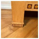 inlaid with contrasting woods, having a cushioned seat with red abstract upholstery, apparently unsi