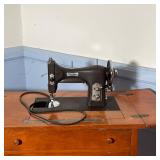 hinged lid to reveal workspace with a Wakefield "Domestic" Sewing Machine inside - l. 27.5 x w. 17.7