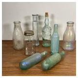 (8pc) GLASS BOTTLES  |  Including blue/purple iridescent glass bottles, an Evergreen Farm milk bottl