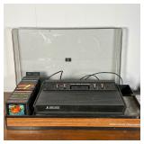 ATARI GAMING CONSOLE  |   Atari 2600 Video Computer System in a lidded case with various games, incl
