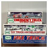 Hess Truck and Helicopter, and a Fire Truck, all in original boxes; plus a red fire truck without bo