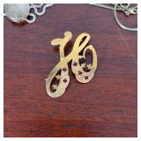 18kt gold pin with 5 red gemstones (3.0g), and a silver-toned chain, unmarked; silver chains 7.3g