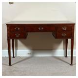 BAKER WRITING DESK  | With two banks of two small drawers centering same middle drawer, with blind f