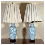 (2pc) PAIR BLUE PORCELAIN LAMPS  | A pair of blue porcelain table lamps with textured floral decorat