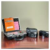 (3pc) CAMERAS ETC  | Including two 35mm film cameras and a cased Simpson Illumination Level Meter