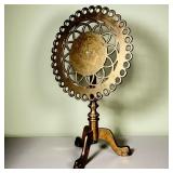 BRASS TILT TOP PLANT STAND | Brass tilt top plant stand with an open work scalloped surface, turned