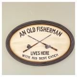 FISHERMAN WALL DECOR | Very punny oval sign with crossed fishing rods that reads "An Old Fisherman