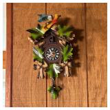 PAINTED CUCKOO CLOCK | 20th century, small cuckoo clock with carved and painted leaves crested