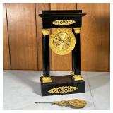 PALATIAL SHELF CLOCK | Open faced clock with Roman numerals, flanked by columns and painted black