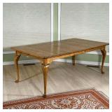 CUSHMAN EXTENSION DINING TABLE |Lightly colored wood extension table with a single leaf, on cabriole