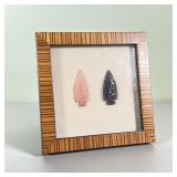FRAMED ARROWHEADS | A pink and a black obsidian arrowhead framed behind glass - w. 7 x h. 7 in. 