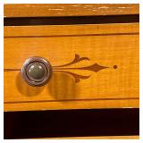 contrasting woods, having four graduated drawers centered by two banks of four smaller drawers.