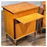 over a slide out over cabinet doors inlaid in contrasting woods, the sides set with full columns