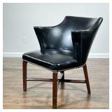 ANTIQUE LIBRARY ARMCHAIR | Black vinyl upholstery with scroll arms and brass tacks, on a wood frame 