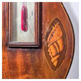 devices in contrasting woods, having a Fahrenheit thermometer with red fluid and a round dial barome