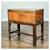 ANTIQUE ENGLISH TRAVEL WRITING BOX | Brass bound with side handles, on a conforming wood stand - 