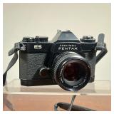 1.8 55mm lens with original manual and leather carrying case, also includes Soligor 19A flash 