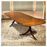 DOUBLE PEDESTAL DINING TABLE | Mahogany and burlwood veneer top, two pedestal sections raised on tri