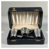 (4PC) STERLING SILVER TABLE SET | Including a salt and pepper, a small lidded vessel with cobalt gla