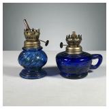 (2PC) PAIR HONG KONG BLUE GLASS OIL LAMPS | Made in Hong Kong, one lamp with fruit reliefs and handl