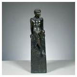 WHITE METAL MALE FIGURE | Nude male figure sitting atop a pedestal.