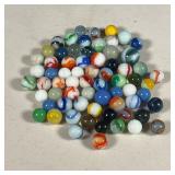 GLASS MARBLES | An assortment of colored glass marbles.