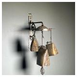 HANGING BRASS BELLS | Set of hammered brass bells hanging from a central disk, illegibly marked on b