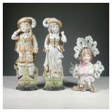 (3PC) BISQUE FIGURES | Including pair of German painted bisque figures of a man and woman, and a bus