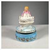 GIRL ON PIANO MUSIC BOX | Designed as a girl in pink dress playing a gilt piano on a blue stage. Dim