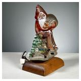GLASS SANTA LAMP | Painted glass Santa Claus lamp with a tree and gifts. Dimensions: l. 6.5 x w. 5 x