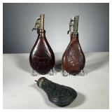 (3PC) POWDER FLASKS | Includes 2 leather black powder measures with spring loaded top, decorated wit