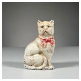 CAST IRON STILL BANK | With original paint, white cat still bank with red bow, held together by a sc