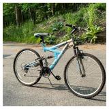 NEXT POWER CLIMBER FULL SUSPENSION BICYCLE | 18 speeds, with blue and silver paint.