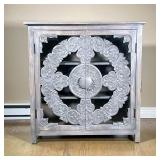CARVED WOOD & GLASS CABINET | Carved gray washed wood and glass doors open to interior shelving. - l