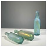 (3PC) IRIDESCENT GLASS BOTTLES | Art glass iridescent bottles, two with rounded bottoms. - h. 9.25 i