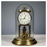 GERMAN SHELF CLOCK | In a glass dome, enameled dial with Arabic numerals. - h. 11 in