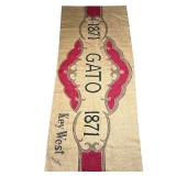 NOELLE ROSE BURLAP FLOOR MAT | Decorated with an oversize cigar wrapper design, "Gato / 1871 / Key W