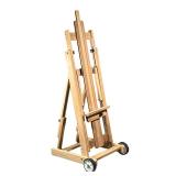 ARTIST’S EASEL | Solid wood with two wheels; folds flat. - l. 20 x w. 7 x h. 54 in (folded)