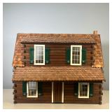 LOG CABIN DOLLHOUSE | Handmade wooden dollhouse designed as a log cabin with green shutters, with so
