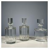 (3PC) GLASS DECANTERS | Including a faceted pair and one decanter of modern oval design, no chips. -