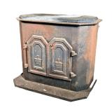 GARRISON WOOD STOVE | Garrison wood burning stove from 1979; double doors with decorative motif. - l
