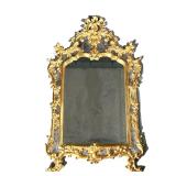 GILT FRAMED MIRROR | Intricately carved gilt frame with sectioned mirrored border, floral and wreath