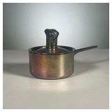 RAYNAUD CALUIRE SMALL POT | Very small white metal sauce pan, signed on the bottom with a figural ha