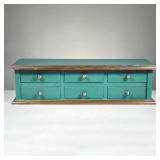 SMALL 6-DRAWER CABINET | Painted green with black handles, contains 6 small drawers with holes in th