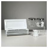 (12PC) MISC KITCHEN ITEMS | Including 7 white rectangular dishes (l. 11 in.), a pair of Pyrex jars w