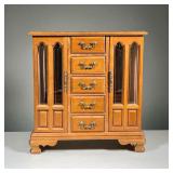 WOOD JEWELRY BOX | Three section jewelry box having two glass-front doors centering a bank of five d
