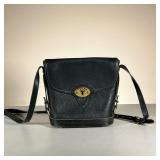 DOONEY & BOURKE LEATHER BAG | Black All Weather Leather shoulder bag with firm base & brass pegs on 