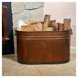 COPPER WASH BOILER | Copper Wash Boiler with brass handles, being used as a fireside wood/log holder