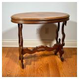OVAL SIDE TABLE | Walnut Oval Table with cut out sides and shaped stretcher. - l. 32 x w. 18 x h. 27